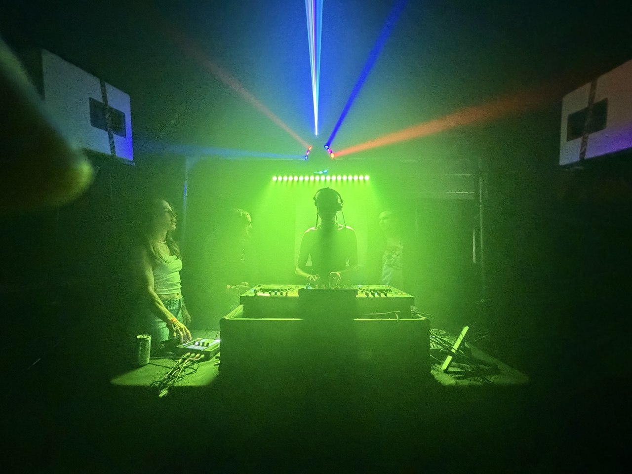 DJ silhouette with green laser lighting production